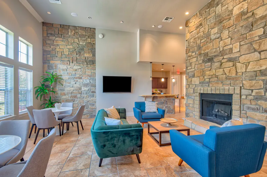 Marbella Bay Apartments clubhouse lounge with stone fireplace